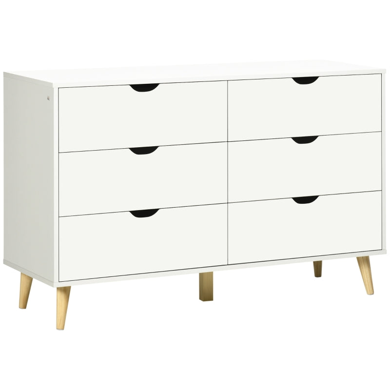Cómoda Aster ancha de 6 cajones en blanco con patas de madera en un dormitorio