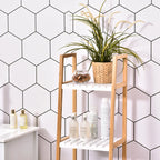 Estantería de baño de bambú apoyada en la pared de un baño de estilo moderno