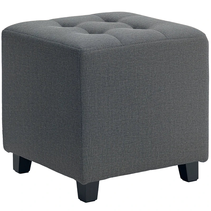 Reposapiés Narvik tapizado en lino gris con patas de madera en un salón