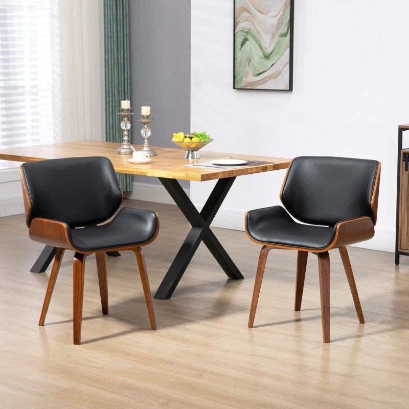 Sillas de comedor negras de estilo vintage alrededor de una mesa