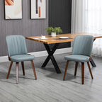 Sillas de comedor grises de estilo moderno alrededor de una mesa
