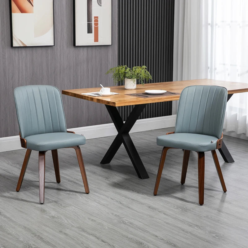 Sillas de comedor grises de estilo moderno alrededor de una mesa