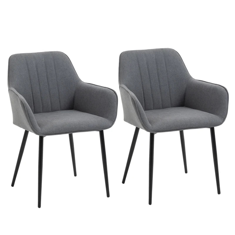 Set de dos sillas de comedor Ashford tapizadas en lino gris con reposabrazos y patas de metal en un comedor moderno
