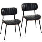 Set de dos sillas de comedor Falkenberg tapizadas en símil piel negro con patas de metal en un comedor moderno