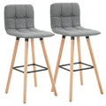 Set de 2 taburetes altos Celle en lino gris con patas de madera en una cocina nórdica
